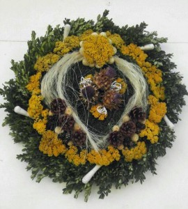 Wreath in front of the Wigmaker's Shop with 18th century style wig curlers and horsehair.