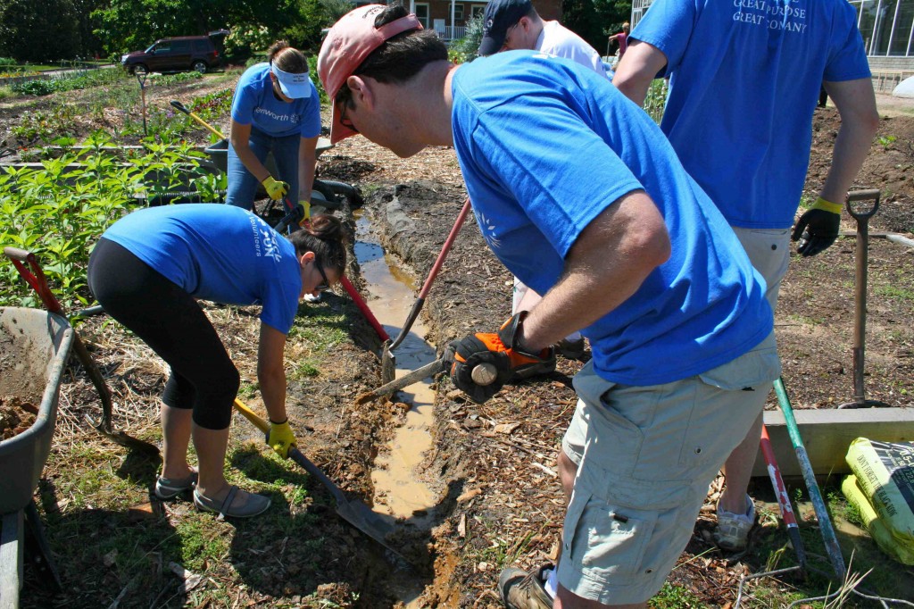 Ditch digging? Yep, but we prefer to call it "trenching". Parts of the CKG hold a lot of water after drenching rainfall. The Genworth team helped to lengthen a drainage trench.