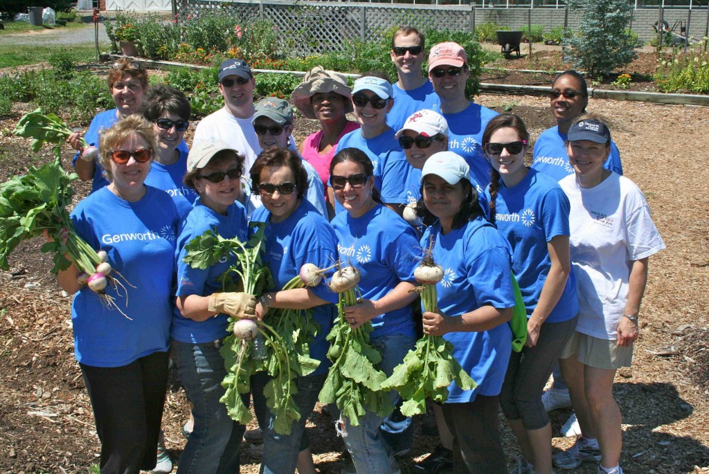 With good humor unsuppressed after 3.5 hours of heavy gardening labor, 17 of the 22 Genworth volunteers display some of the results of their labor. The Genworth team was led by Jen Phillips (front row, second from right).