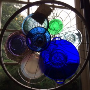 Recycled bike wheels decorated with vintage glass plates.