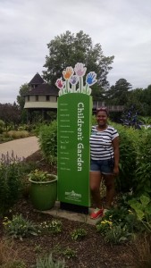 Henrico High School IB student Lia Bazemore in the Children's Garden. Bazemore is here as an intern with Partnership For the Future.