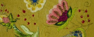 Pink flowers and red berries in this Jacobean embroidery highlight the beauty of this botanical art by student Alicia Clayton Vidal