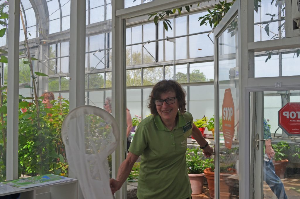 Sherry Giese is pictured smiling in the exhibit vestibule.