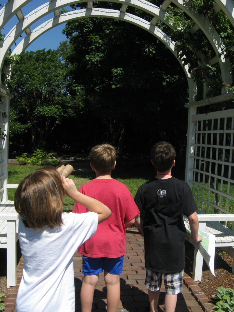 Lucy uses her bird-watching binoculars to get a more focused look at the mourning dove nest in the Grace Arents Garden.