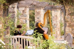Acoustic instruments play at outdoor wedding venue, the Rose Garden. Image by J&D Photography