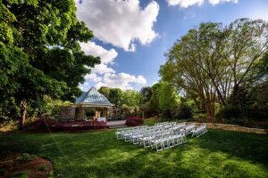 Outdoor weddings at Flagler Garden surround guests with blooms and greenery. Image by Marek K Photography.