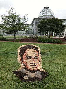 Grace Arents portrait in gravel, mulch and terra cotta. Pop-up ephemeral art by Richmond artist Noah Scalin.