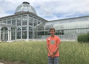 Summer camp helper Jacob Ellis in front of the Conservatory.