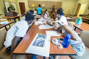 Children's Garden Horticulturist Heather Veneziano offered her expertise and answered questions from these students as they firmed up their plan. From left to right: DeAndre Dublin, of George Wythe High School, Heather Veneziano, Simone Turner, of Armstrong High School, and Malaisha Tims, of Verina High School.