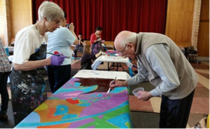 Visitors painting an interactive mural