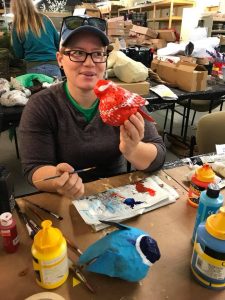 Hand painting paper mache animals.