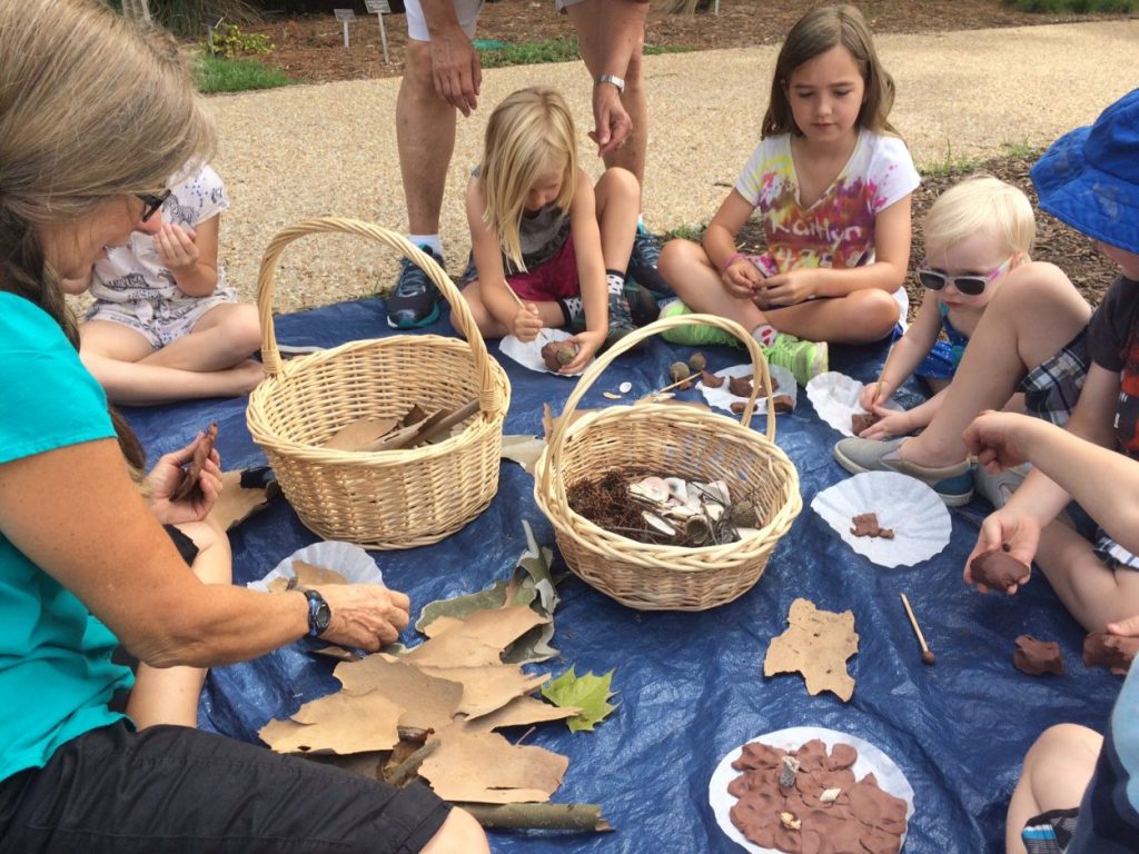 Children learning about nature hands on in the garden. 