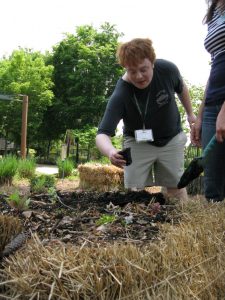 Ethan Lindsey, a youth with autism engaged in a gardening program at Lewis Ginter Botanical Garden.