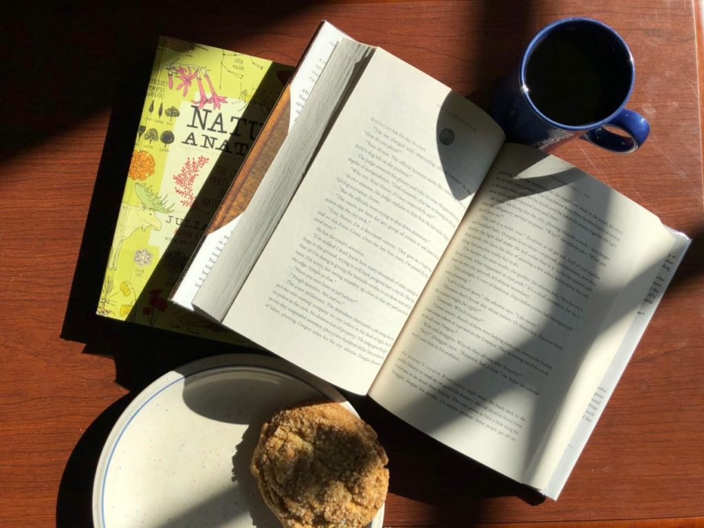 Two books, a cup of coffee, and a cookie