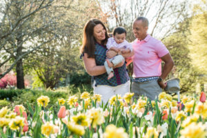 Family with small child enjoying the blooms at Lewis Ginter Botanical Garden in spring. Dad.