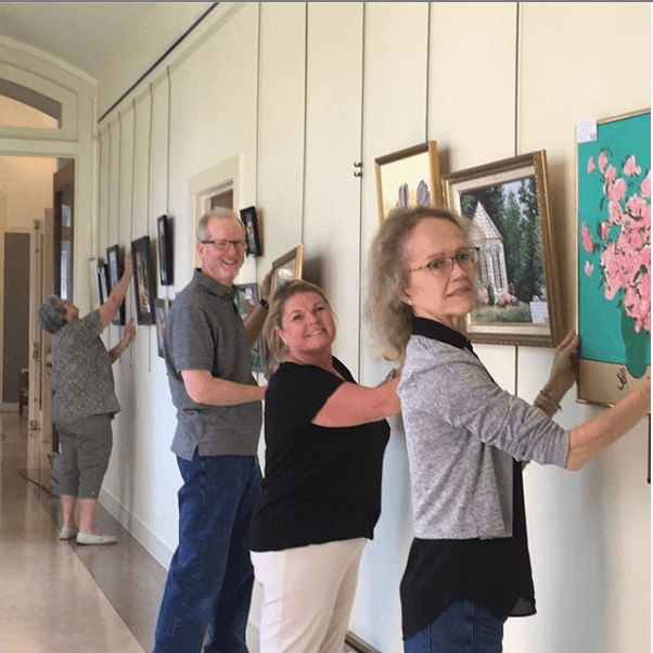 The James River Art League hanging their show