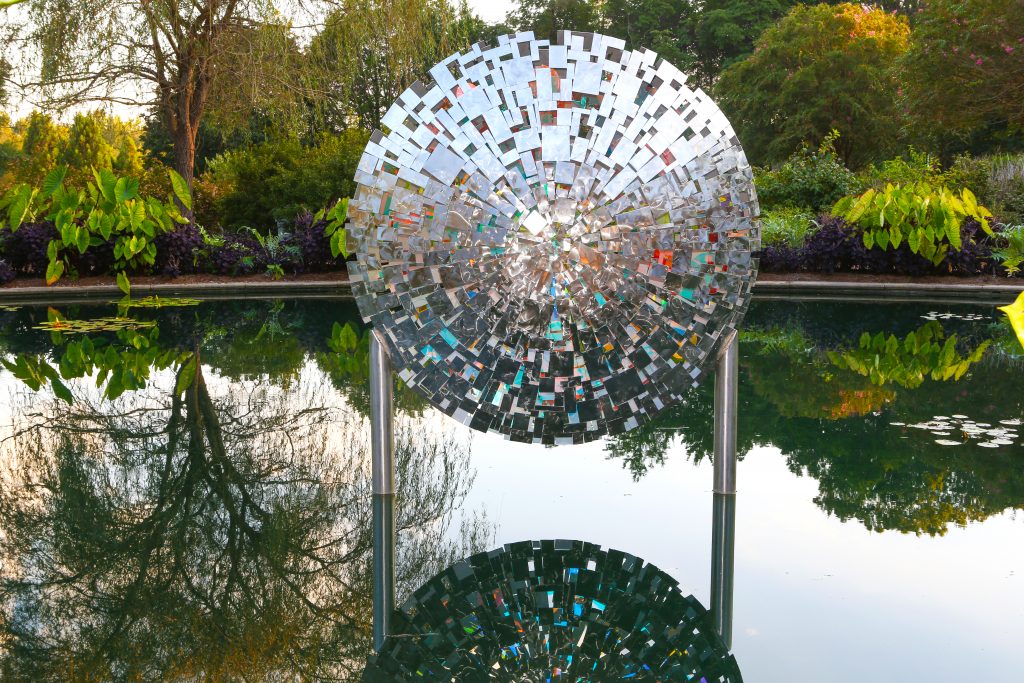 Colarium sculpture floating above water