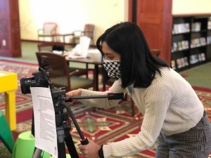 Claudine Reyes sets up camera to film virtual storytime.