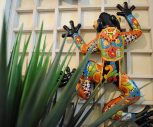 colorful clay Talavera frog climbing the wall