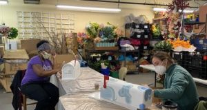 Unicia Buster and Carrie Cheatham, local artists, each painting a mailbox