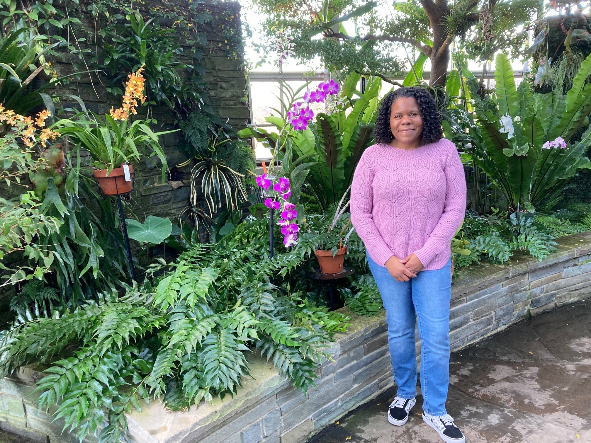 Leanne Wingo with a Phalaenopsis orchid and more in the Orchid Wing of the Conservatory