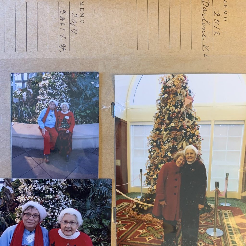 Volunteer Mariette Norbom and other volunteers in front of the christmas tree