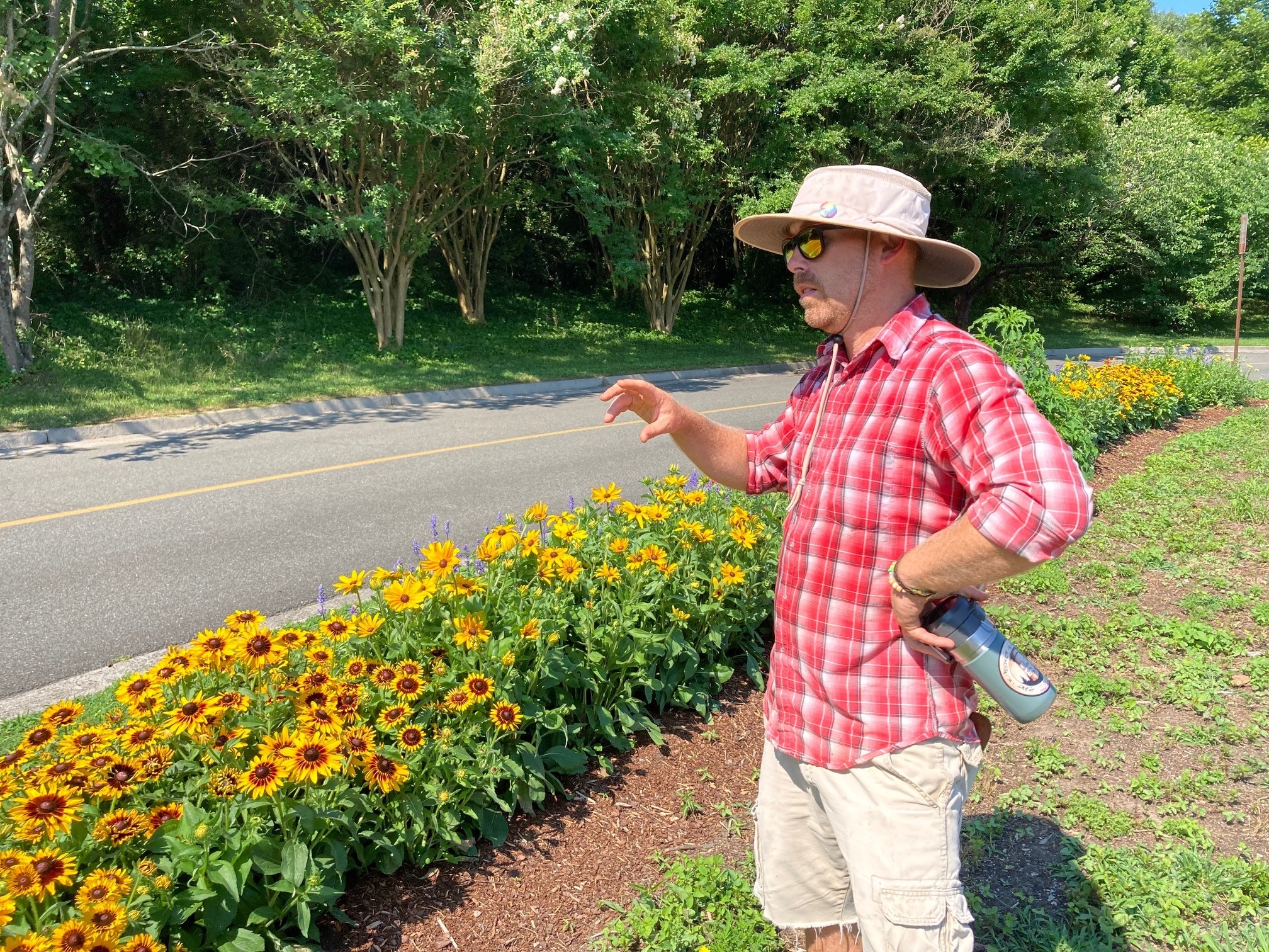 Sustainable Gardener Mikey Partusch and flowers he planted to beautify the garden