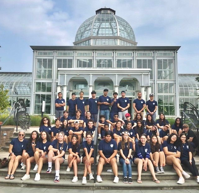 Students from the Latino Education Advancement Program in front of Lewis Ginter Botanical Garden's Conservatory