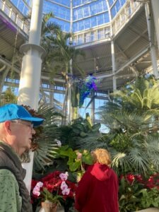 Bob Lincoln shows guests the hummingbird light form in the Conservatory. Photo by Meredith Orne.